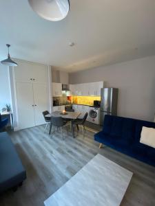 a living room with a blue couch and a table at Modern and spacious city centre apartment in Dublin