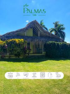 a small house with a thatched roof at Villa Las Palmas in Las Galeras