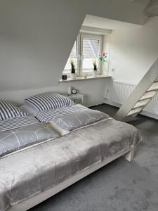 a bedroom with a bed and a stair case at Ferienwohnung Südel App.2 in Malente