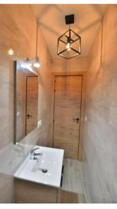 a bathroom with a white sink and a mirror at casa el olivo in Montejaque