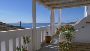 a white porch with a view of the ocean at Ageri Studios in Astypalaia Town