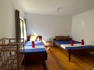 a room with two beds and a couch in it at Happy Elephant Bungalows in Koh Rong Island