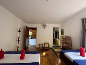 a room with two beds with red pillows at Happy Elephant Bungalows in Koh Rong Island