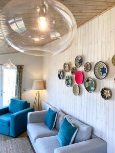 a living room with a couch and plates on the wall at Ribblesdale Park in Gisburn