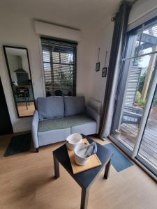 a living room with a couch and a table at Le Prevet in Saint Malo