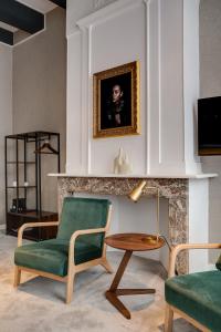 a living room with a green chair and a table at The Sixteen in Amsterdam