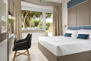 Posteľ alebo postele v izbe v ubytovaní Golf Hotel Punta Ala