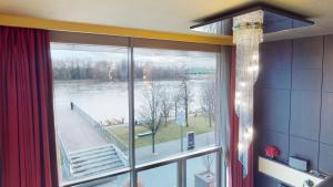 a room with a window with a view of a river at Eurovea Apartments in Bratislava