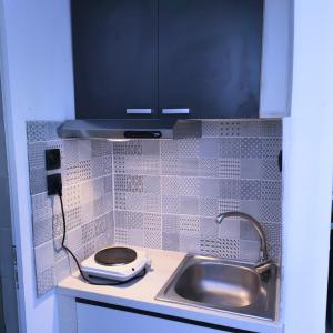 a small kitchen with a sink and a toilet at Seaside apartment in Agioi Theodoroi