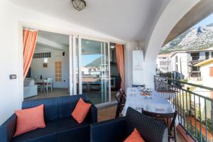 a room with a table and chairs and a balcony at Royal Suite Apartment in Cala Gonone