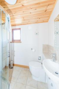 a bathroom with a tub and a sink at Barn Lodge with Hot Tub in Cupar