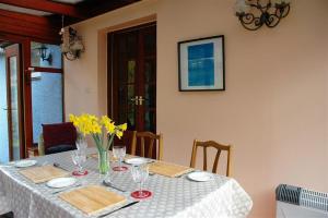 a table with a white table cloth and yellow flowers on it at Pinesmoke in Killin