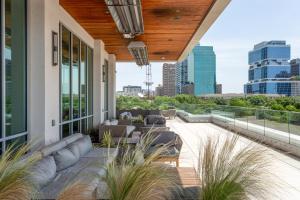 a patio with furniture and a view of the city at Mint House Dallas - Victory Park in Dallas