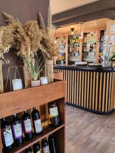 a store with bottles of wine on a shelf at Family Hotel Diana in Tsarevo +17 photos