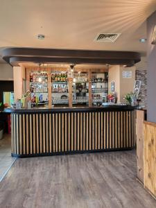 a bar in a restaurant with a wooden counter at Family Hotel Diana in Tsarevo