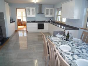 a kitchen with a table with wine glasses on it at Derryleigh House 