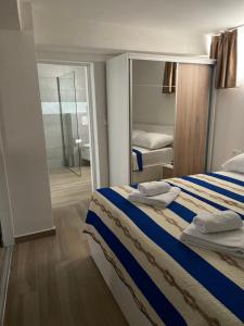 A bed or beds in a room at Tisno Resort