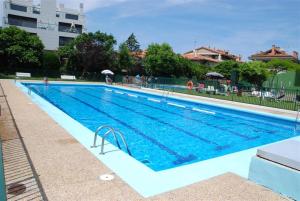 a large swimming pool with blue water at ATeRIAN EUROMAR I in Zarautz