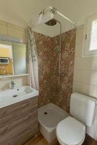 a bathroom with a toilet and a sink and a shower at La Punta Geronimi in Porto Pollo