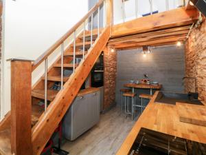 a loft conversion with a staircase and a table at Eventide in Plymouth