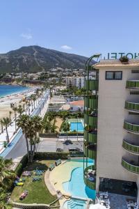 a view of a resort with a pool and a beach at KAKTUS Hotel Kaktus Albir in Albir