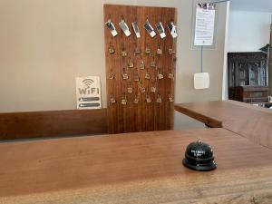 a room with a wooden wall with pairs of shoes at Logis Hotel De La Clape in Narbonne-Plage