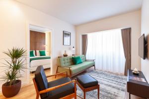 a living room with a couch and a bed at Avenida Residence in Braga