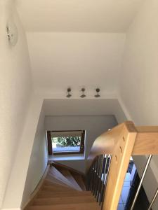 a staircase in a house with a window at La Mouette Rose - a zen guest-house in Lauterbourg 