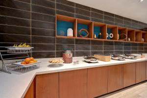 a kitchen with a counter with fruit on it at SpringHill Suites by Marriott Albuquerque University Area in Albuquerque