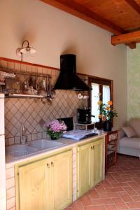a kitchen with a sink and a stove at Casetta Marieoria Chia in Chia