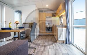 a kitchen and dining room with a table and a window at Tiny Haus 17 Am Brombachsee in Pleinfeld