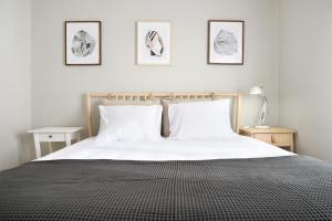 En eller flere senge i et værelse på Sé Apartamentos - BragaXXI