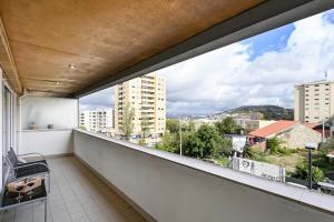 a balcony with a view of a city at Sé Apartamentos - Casa Cecília in Braga