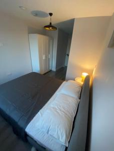 a large bed in a room with a light at Modern and Cosy 1-Bed Apt in the Heart of Dublin in Dublin