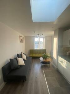 a living room with a couch and a table at Modern and Cosy 1-Bed Apt in the Heart of Dublin in Dublin