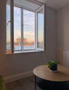 a room with a table and a large window at Modern and Cosy 1-Bed Apt in the Heart of Dublin in Dublin