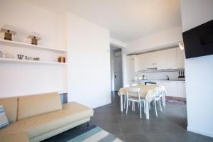 a living room and kitchen with a couch and a table at Silvia al mare in Diano Marina