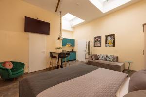 a bedroom with a bed and a living room at Fabric Apartments in Dettingen an der Erms