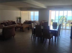 a living room with a table and chairs and a couch at Bay view grand residencial - 3 beds-501 in Ixtapa