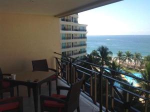 a balcony with a table and chairs and the ocean at Bay view grand residencial - 3 beds-501 in Ixtapa