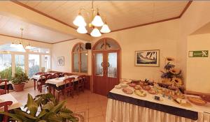 a dining room with a table with food on it at Hotel Stanger in Lovran