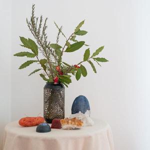 a table with a vase and some cookies on it at Bed and Breakfast Villa Alba in Controguerra +6 photos