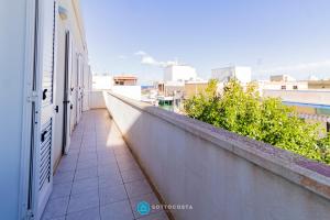 a balcony of a building with a view of a city at MADREPERLA - SAN FOCA in San Foca