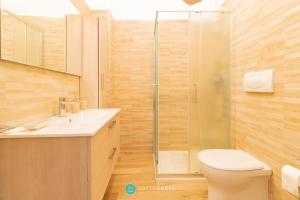 a bathroom with a shower and a toilet and a sink at MADREPERLA - SAN FOCA in San Foca