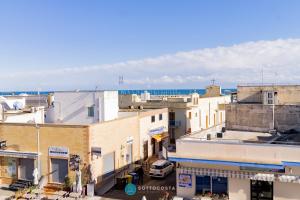 an aerial view of a city with buildings and the ocean at MADREPERLA - SAN FOCA in San Foca