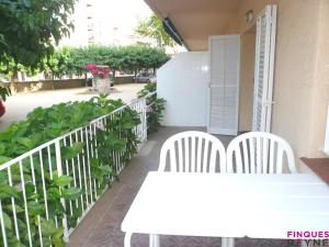 d'une table et de chaises blanches sur un balcon. dans l'établissement Algues apt 8, à Platja d'Aro