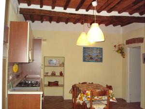 a kitchen with a table and a kitchen with two lights at Appartamenti Piombino Isola d'Elba in Rio Marina