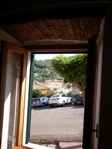 a window view of a parking lot with cars parked at Appartamenti Piombino Isola d'Elba in Rio Marina