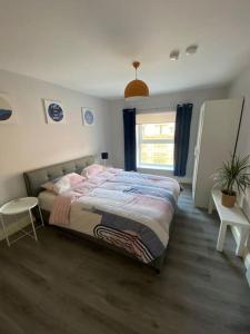 a bedroom with a large bed and a window at Central 2-bed Apartment in Dublin