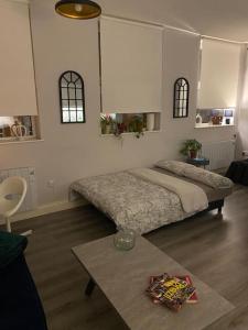 a bedroom with a large bed and a table at Central 2-bed Apartment in Dublin